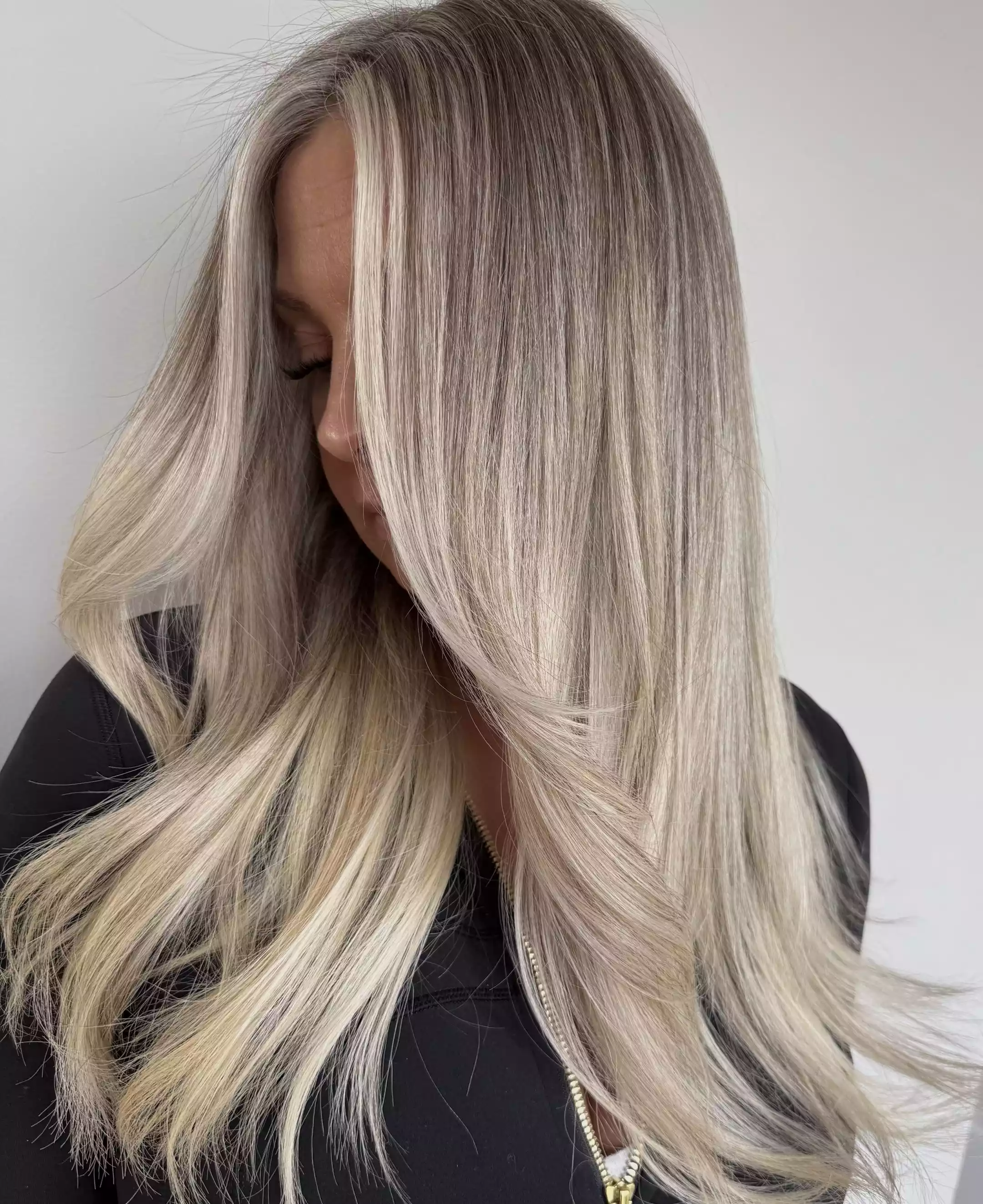 Long ash-blonde hair with dimensional highlights and soft waves